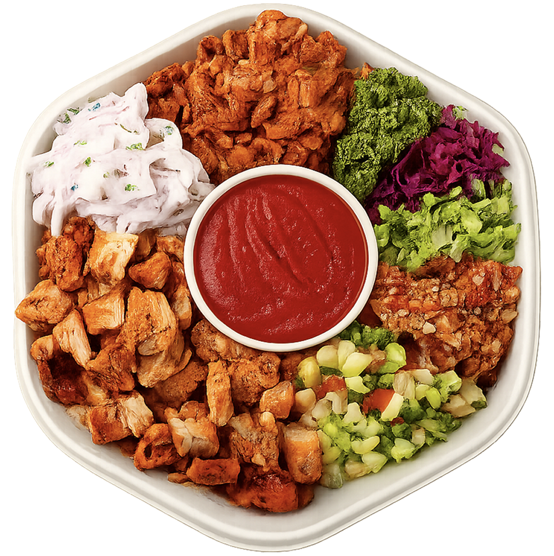 Top-down view of a Gully Bowl with spiced chicken, raita, purple cabbage slaw, greens, corn salsa and dipping sauce